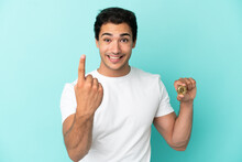 Young Man Holding A Bitcoin Over Isolated Blue Background Doing Coming Gesture