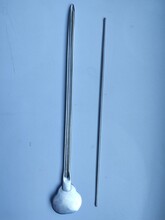 Buttoned And Grooved Metal Clean Medical Probe Lie On A Blue Surface In A Hospital