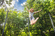 © Dmitry Naumov - Preteen girl having fun bouncing on a trampoline in a backyard on a summer day