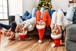 © Krakenimages.com - Group of young people celebrating christmas lying on de sofa with funny position at home