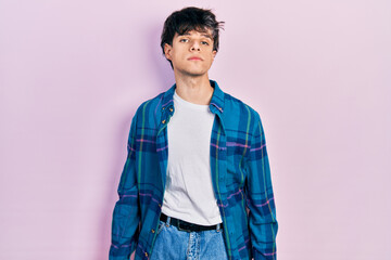 Sticker - Handsome hipster young man wearing casual white t shirt and vintage shirt relaxed with serious expression on face. simple and natural looking at the camera.