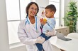 © Krakenimages.com - Mother and son pediatrician and patient hugging each other at clinic