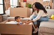 © Krakenimages.com - Mother and son playing with cardboard as a car at new home