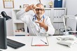 © Krakenimages.com - Mature doctor man at the clinic smiling making frame with hands and fingers with happy face. creativity and photography concept.