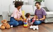 © Krakenimages.com - Couple and daughter smiling confident playing with toys sitting on the floor at home