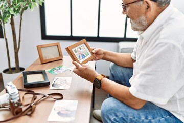 Sticker - Senior grey-haired man smiling confident looking picture at home