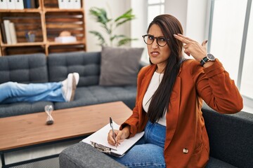 Sticker - Young hispanic woman working as psychology counselor shooting and killing oneself pointing hand and fingers to head like gun, suicide gesture.