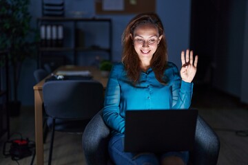 Poster - Brunette woman working at the office at night showing and pointing up with fingers number four while smiling confident and happy.