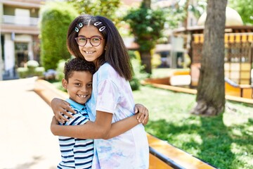 Poster - African american brother and sister smiling happy outdoors. Black family of two siblings at the city on a sunny day.