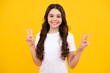 Happy teenager, positive and smiling emotions of teen girl. Funny teenager child girl show peace cool v-sign isolated over yellow background.