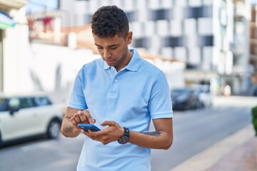 Poster - African american man using smartphone at street