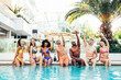 © Davide Angelini - Multiracial friends drinking champagne together on pool party - Diverse young people having fun at a holiday resort - Summer vacations concept with guys and girls hanging outside together