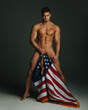 canvas print picture - Sexy fitness male model with American flag covering his naked body