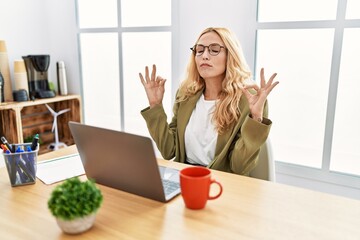 Sticker - Beautiful blonde woman working at the office with laptop relax and smiling with eyes closed doing meditation gesture with fingers. yoga concept.