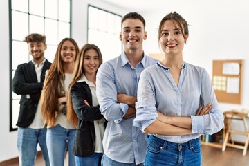 Group of young business workers smiling happy standing with arms crossed gesture at the office.