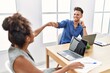© Krakenimages.com - Man and woman business workers smiling confident bump fists at office