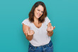 Young plus size woman wearing casual white t shirt showing middle finger doing fuck you bad expression, provocation and rude attitude. screaming excited