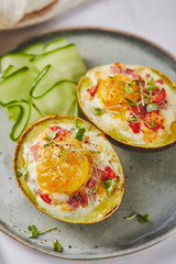 Wall Mural - Avocado baked with egg, ham, tomatoes and cheese. Keto lunch recipe. After baking