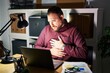 © Krakenimages.com - Plus size hispanic man with beard working at the office at night with hand on stomach because indigestion, painful illness feeling unwell. ache concept.