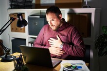 Plus Size Hispanic Man With Beard Working At The Office At Night With Hand On Stomach Because Indigestion, Painful Illness Feeling Unwell. Ache Concept.