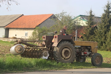 combiner plows the ground tractor driver plows the soil for planting wheat