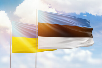 Wall Mural - Sunny blue sky and flags of estonia and ukraine