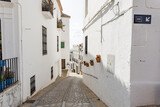 Fototapeta  - Typical narrow street in Zahara de la Sierra, in Sierra de Grazalema, Cadiz, Andalusia, Spain