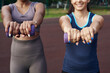 © etonastenka - Close up diverse women holding dumbbells and doing exercises outdoors
