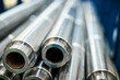 © nordroden - Pile of long drill rods metal workpieces in light warehouse