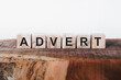 Advert Word Written In Wooden Cube