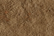 Stone wall concrete rough cracked porous dark brown surface texture