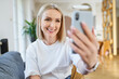 © baranq - Closeup of mid adult woman doing video call on smartphone at home