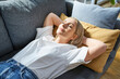 © baranq - Nap time. Adult woman sleeping on a sofa at home during a day