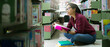© Tawan - Portrait of asian college girl reading book in library ready for exam