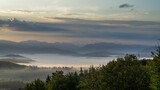 Fototapeta Na ścianę - Dawn over the mountains and the birth of clouds from the fog.