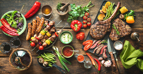 Grilled meats and vegetables on rustic picnic table