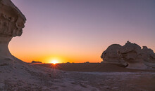 Sunrise In The White Desert With The Sun Coming Up Behind The Rock Formations In Egypt