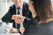 © crizzystudio - Successful deal Real estate lease or home purchase concept buyer shakes hands with bank employee after office contract is completed.