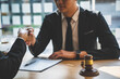 © crizzystudio - Handshake after good cooperation counseling lawyer business lawyers working about legal legislation, Consultation between a male lawyer and businessman customer, and the company of real estate concept