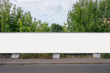 advertisement long empty banner mounted on cement fence outdoor. construction industry and developme