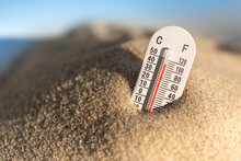 Weather Thermometer With High Temperature Outdoors In The Sand