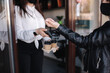 © Aleksandr - Female customer making wireless or contactless payment using smartwatch. Cashier accepting payment over nfc technology. Two people in face mask during quarantine. Covid19