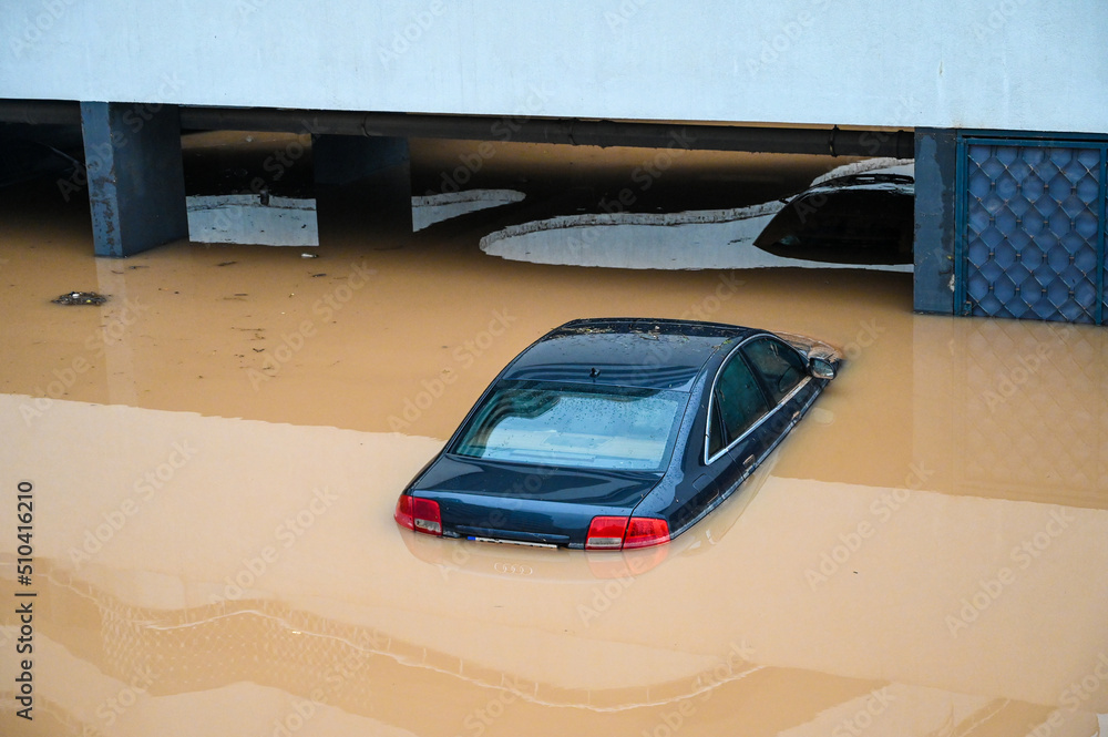 Flooded cars in parking. River floods in the city. Cars submerged in ...