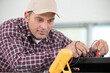 © auremar - close-up electrician measuring voltage of a box