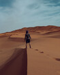 person walking in desert