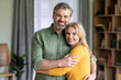 © Prostock-studio - Portrait Of Middle Aged Romantic Couple Embracing And Smiling At Camera