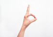 © Paul - Mano de un hombre delgado haciendo un signo con la mano de aceptación en un fondo blanco aislado