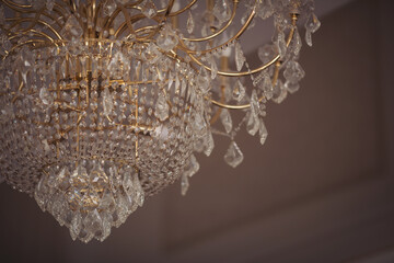 Wall Mural - large round chandelier with crystals and candlesticks on the ceiling,  dark background, retro style. Beautifulchandelier in luxury room shining.