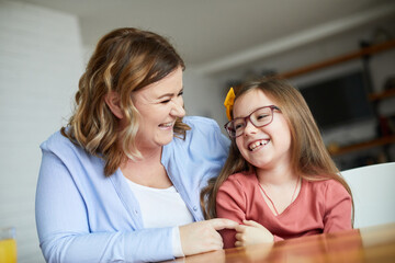 Wall Mural - child mother family parent home woman happy playing daughter kid together indoor hug hugging kiss