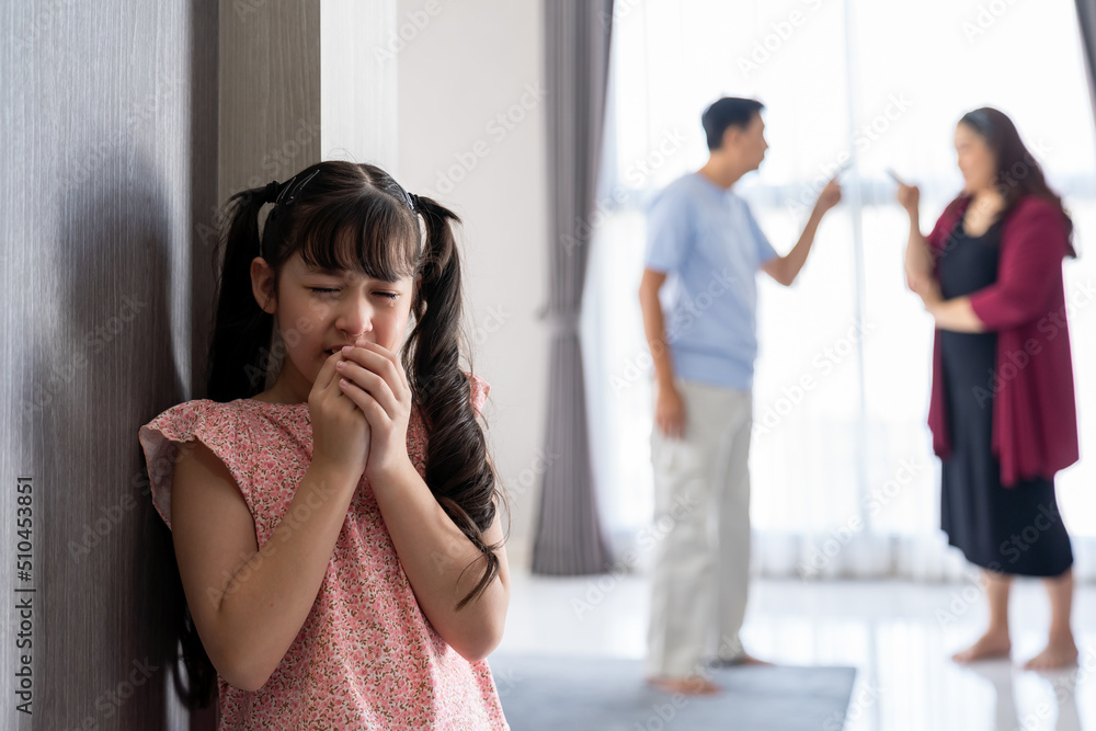 Sad child girl crying with wet eyes from tears from father and mother ...